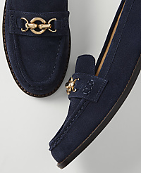 A pair of navy blue suede loafers with gold hardware rests on a plain white background. carousel Product Image 2