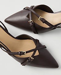 A pair of dark brown pointed-toe slingback heels with delicate straps and gold buckles are displayed against a plain white background. carousel Product Image 2