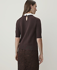 A woman in a brown sweater and lace skirt stands against a plain white background. carousel Product Image 2