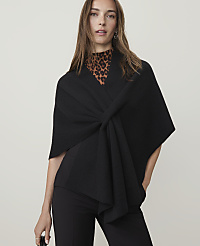 A woman in a black wrap and leopard print top stands against a plain background. carousel Product Image 1