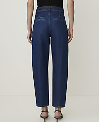 A person wearing dark wash, wide-leg denim jeans stands against a plain, light-colored background. carousel Product Image 3