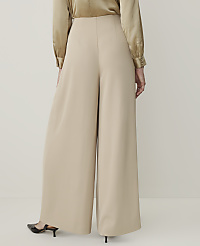 A person wearing beige wide-leg pants and a gold satin blouse stands against a plain white background. carousel Product Image 3