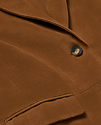 A woman in a brown suit and white polka dot blouse stands with a black clutch against a plain white background. carousel Product Image 4