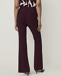 A person wearing burgundy flared trousers and a patterned top stands against a plain white background. carousel Product Image 3