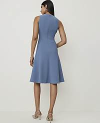 A woman in a blue sleeveless dress stands against a plain, light-colored background. carousel Product Image 2