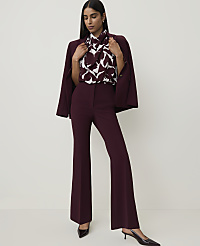 A woman in a burgundy suit with a patterned blouse stands against a plain white background. carousel Product Image 1