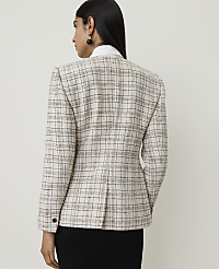 A woman in a tweed blazer stands against a plain, light-colored background. carousel Product Image 2