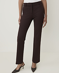 A person models dark brown dress pants and slingback heels against a plain white background. carousel Product Image 2