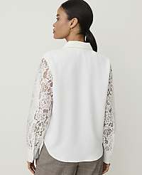 A woman in a white blouse with lace sleeves stands against a plain white background. carousel Product Image 2