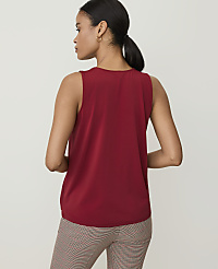A woman in a red sleeveless top and patterned pants stands against a plain white background. carousel Product Image 2