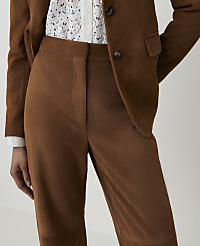 A person wears a brown suede suit with a white lace top, against a plain background. carousel Product Image 4