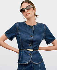 A woman in a denim jacket and skirt, wearing sunglasses, stands against a plain white background. carousel Product Image 3