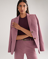 A woman in a mauve blazer and matching pants stands against a plain, light gray background. carousel Product Image 5