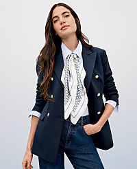 A woman in a navy blazer and jeans stands against a plain white background. carousel Product Image 3