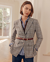 A woman in a plaid blazer and striped shirt stands in a well-lit room with a window in the background. carousel Product Image 3
