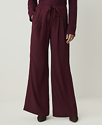 A person stands in maroon wide-leg pants and a maroon sweater against a plain white background. carousel Product Image 2