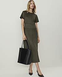 A woman in a green dress and heels holds a black tote bag in front of a plain white background. carousel Product Image 1