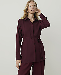 A woman in a burgundy tunic and pants stands against a plain, light gray background. carousel Product Image 1