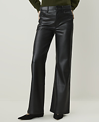 A person wearing black faux leather flared pants and a green sweater stands against a plain beige background. carousel Product Image 2