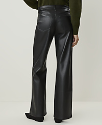 A person wearing black faux leather pants stands against a plain, light-colored background. carousel Product Image 3