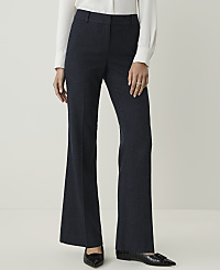 A person in a white blouse and dark patterned pants stands against a plain, light background. carousel Product Image 2