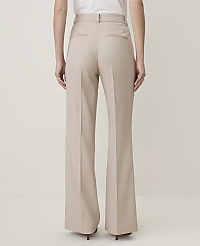 A person wearing beige wide-leg trousers stands against a plain, light-colored background. carousel Product Image 2