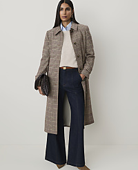 A woman in a plaid coat and wide-leg jeans stands against a plain, light background. carousel Product Image 1