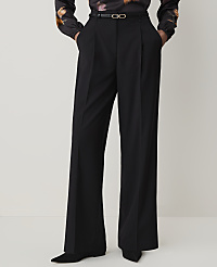 A person stands in black wide-leg pants and a patterned blouse against a plain white background. carousel Product Image 2