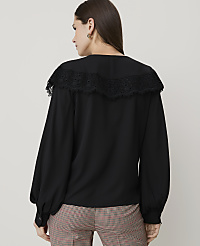 A woman in a black blouse with a lace collar stands against a plain white background. carousel Product Image 2