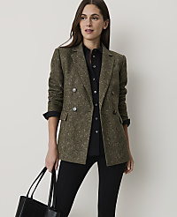 A woman in a tweed blazer and black shirt holds a tote bag in front of a plain background. carousel Product Image 1