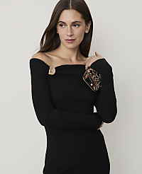 A woman in a black off-the-shoulder dress holds a jeweled clutch in the foreground against a plain, light background. carousel Product Image 2