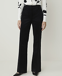 A person stands in black corduroy flared pants and a white floral sweater against a plain white background. carousel Product Image 2