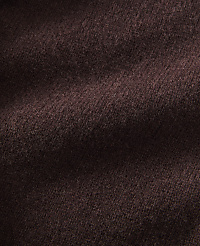 A close-up view of dark brown, textured fabric fills the frame, with soft folds and shadows creating depth. carousel Product Image 2