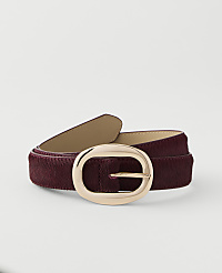 A burgundy belt with a gold oval buckle is laid out against a plain white background. carousel Product Image 1