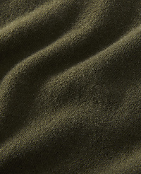 A close-up of olive green fabric with soft folds fills the frame, creating a textured and muted background. carousel Product Image 2