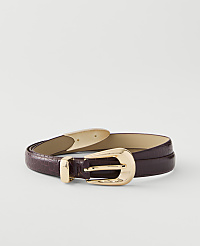 A dark purple, textured belt with a gold buckle lies on a plain white background. carousel Product Image 1