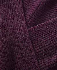 A close-up view of a ribbed, plum-colored knit fabric folds over itself, creating a textured background. carousel Product Image 4