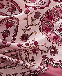 A close-up of a pink silk fabric with a paisley and floral pattern in shades of pink and maroon fills the frame, with soft folds creating subtle shadows and highlights. carousel Product Image 2