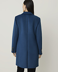 A woman in a teal coat stands against a plain, light gray background. carousel Product Image 2