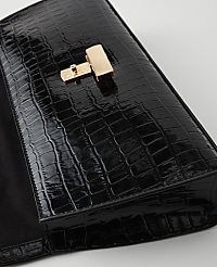 A glossy black crocodile-embossed clutch with a gold clasp rests on a plain white surface. carousel Product Image 2