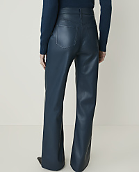 A person wearing teal faux leather flared pants stands against a plain, light-colored background. carousel Product Image 3