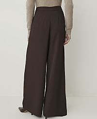 A person wearing brown wide-leg pants and a beige sweater stands against a plain white background. carousel Product Image 3
