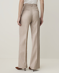 A person wearing beige wide-leg trousers stands against a plain, light-colored background. carousel Product Image 3