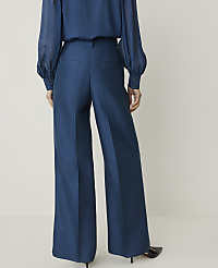 A person wearing a blue blouse and wide-leg blue pants stands against a plain white background. carousel Product Image 3