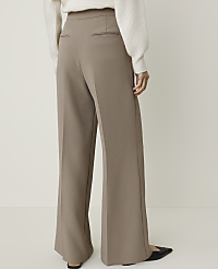 A person wearing wide-leg taupe pants and a white sweater stands against a plain white background. carousel Product Image 3
