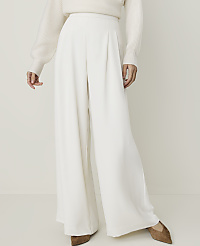 A person in a cream sweater and white wide-leg pants stands against a plain, light background. carousel Product Image 2