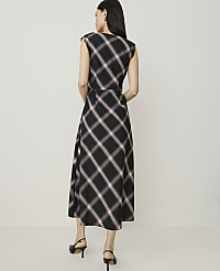 A woman in a plaid dress stands against a plain, light-colored background. carousel Product Image 2