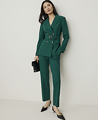 A woman in a green pantsuit and black heels stands with a clutch in her hand against a plain white background. carousel Product Image 4