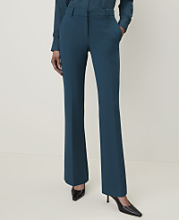 A person stands in teal trousers and black heels against a plain, light background. carousel Product Image 2