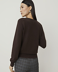 A woman in a brown sweater and plaid pants stands against a plain background. carousel Product Image 2